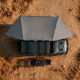 NaturNest 180° Car Awning — Feature shot: overhead view of the full 180-degree shade footprint