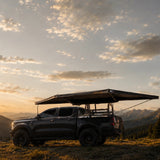 NaturNest 180° Car Awning — Feature shot: side profile showing the sloped canopy and adjustable support pole height