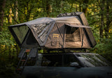 Roofnest Condor Overland 2 XL Air — Lifestyle shot: open tent with window awnings propped open on a Rivian at a green forest camp