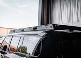 Backwoods Adventure Mods DRIFTR Roof Rack (2024–2027 Land Cruiser 250) — Lifestyle shot: black Land Cruiser 250 showing the low-profile rack