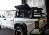 Backwoods Adventure Mods Bed Rack Storage Box (2005–2027 Tacoma) — Feature shot: gas struts holding the lid open