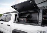 Backwoods Adventure Mods Bed Rack Storage Box (2005–2027 Tacoma) — Feature shot: lid open showing the shelving