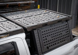 Backwoods Adventure Mods DRIFTR Bed Rack Topper (2005–2027 Tacoma) — Lifestyle shot: topper on a 3rd gen Tacoma bed rack loaded with accessories