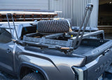 Backwoods Adventure Mods Overland Bed Rack Mid Height (2007–2027 Tundra) — Lifestyle shot: Tundra with a spare tire and gear carried on the rack