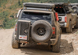 Backwoods Adventure Mods Overland Storage Box (Universal) — Lifestyle shot: Toyota Land Cruiser driving off-road with the box mounted
