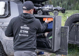 Backwoods Adventure Mods Overland Storage Box (Universal) — Lifestyle shot: unloading gear from the box at camp